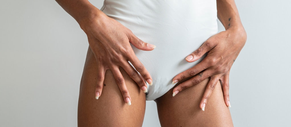 Hands resting on the bikini line